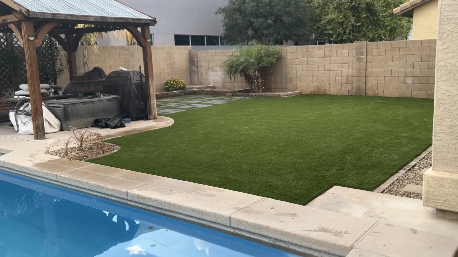 Daniel's Phoenix backyard after replacing sod with artificial turf: clean green install bordering a pool and gazebo