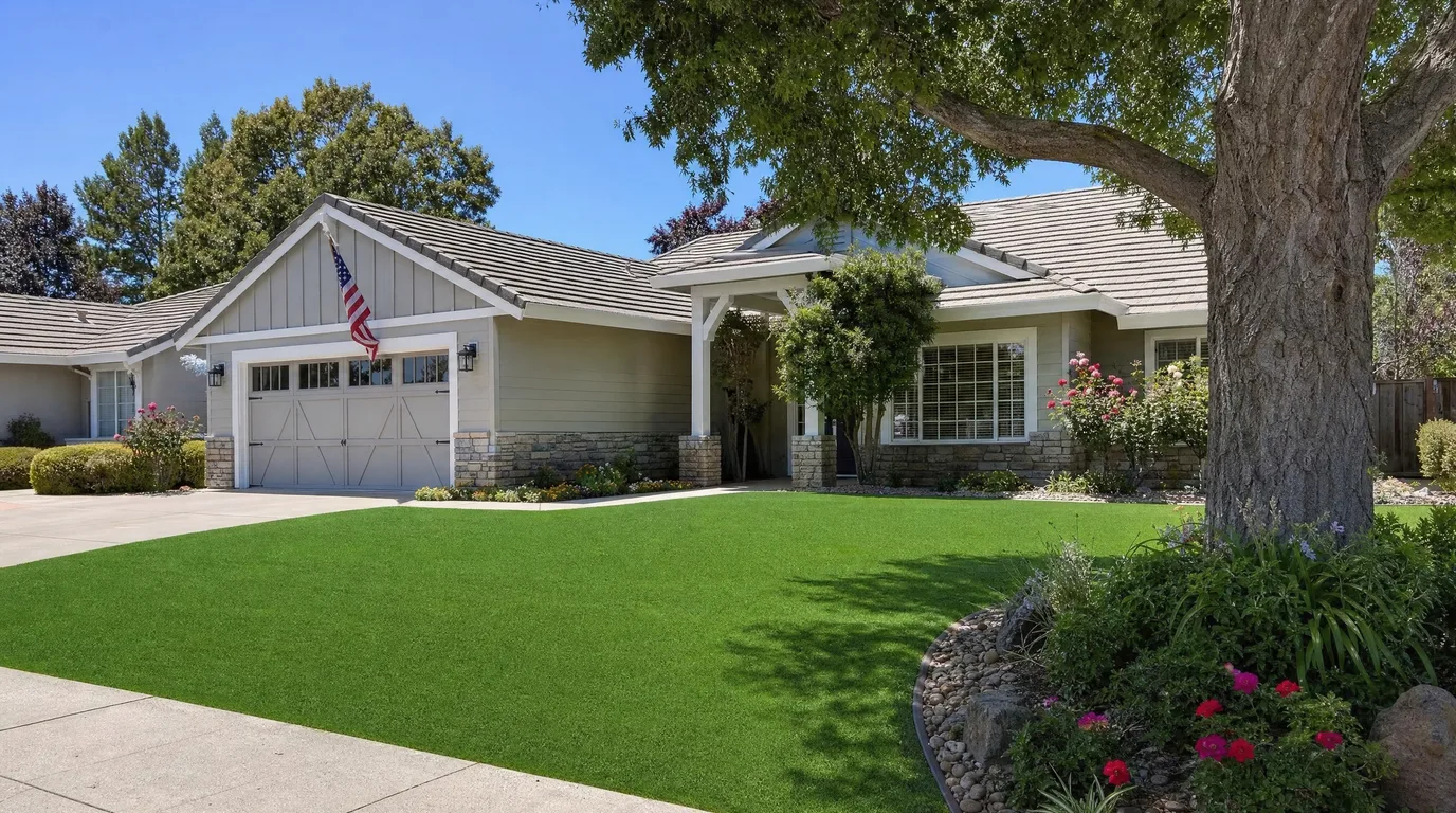 A flawless green artificial turf front lawn on an attractive suburban home