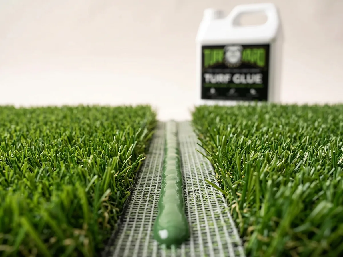 A bead of The Turf Yard artificial turf glue applied along seam tape joining two pieces of artificial grass