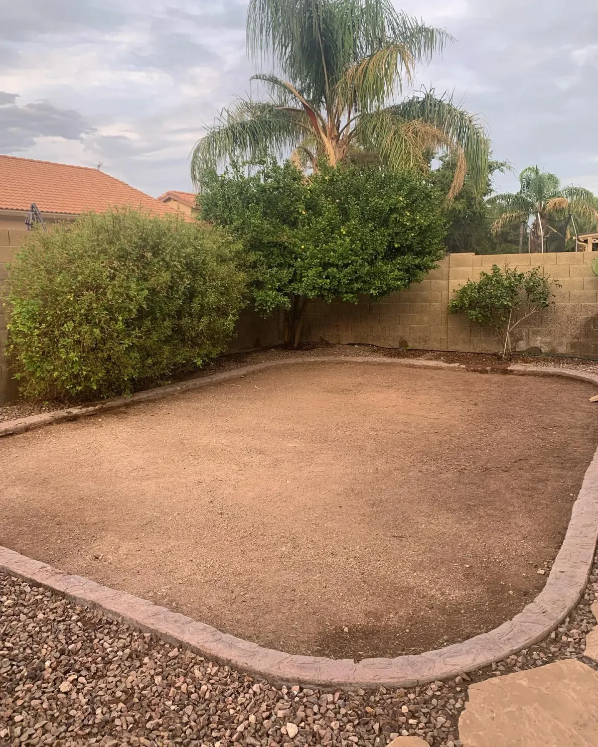 Thin, worn yard before artificial turf installation by The Turf Yard